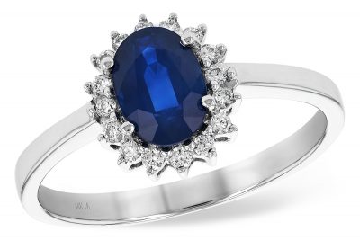 Oval Sapphire ring with .83ct Oval Sapphire surrounded by round accenting G SI1/ SI2 diamonds totaling .14ct, 14k white gold