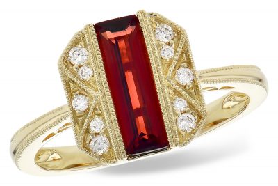 Vintage style ring with elongated emerald cut mozambique garnet in the center, accenting round diamond set down the sides, 14k yellow gold, diamonds totaling .11ct